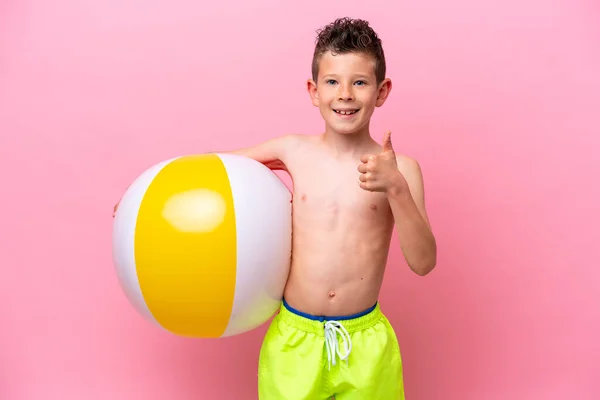 Little Caucasian Boy Holding Beach Ball Isolated Pink Background Thumbs — Zdjęcie stockowe