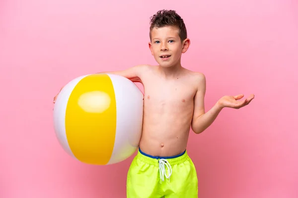 Little Caucasian Boy Holding Beach Ball Isolated Pink Background Shocked —  Fotos de Stock