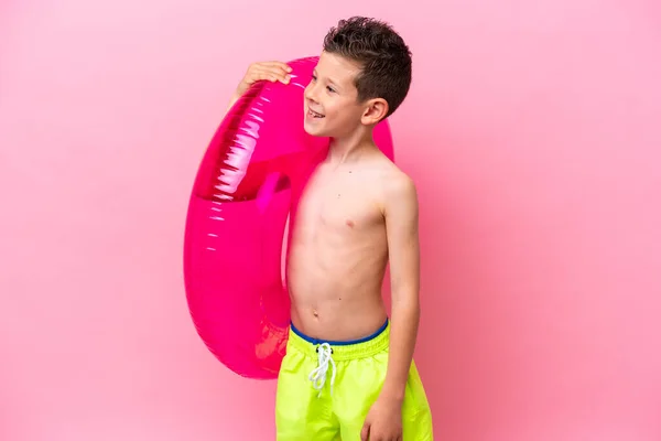 Little Caucasian Boy Holding Inflatable Donut Isolated Pink Background Looking — Stock Photo, Image