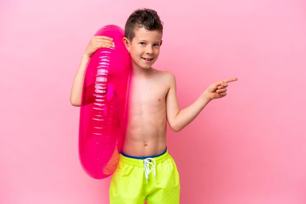 Little Caucasian Boy Holding Inflatable Donut Isolated Pink Background Pointing — Photo