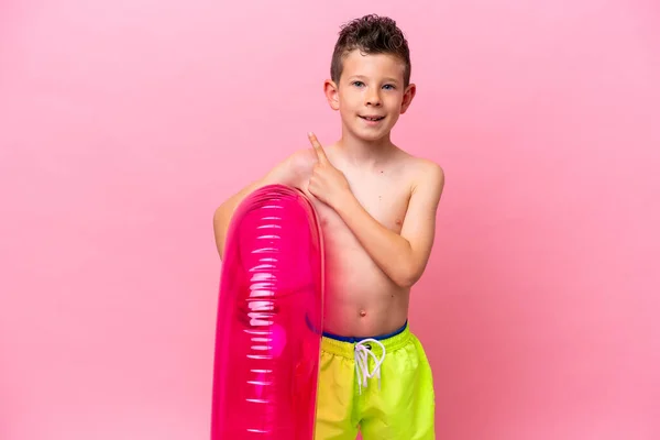 Little Caucasian Boy Holding Inflatable Donut Isolated Pink Background Pointing — Photo