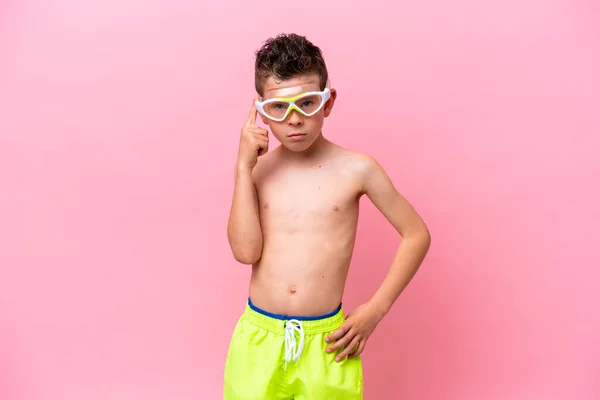 Little Caucasian Boy Wearing Diving Goggles Isolated Pink Background Thinking — Fotografia de Stock