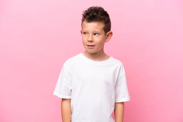 Little Caucasian Boy Isolated Pink Background Making Doubts Gesture Looking — Stockfoto