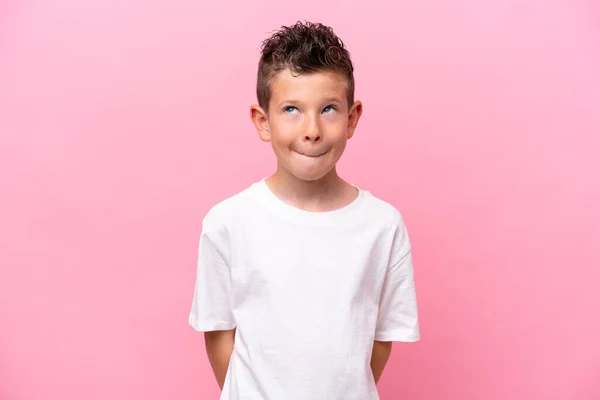 Little Caucasian Boy Isolated Pink Background Having Doubts While Looking — стоковое фото