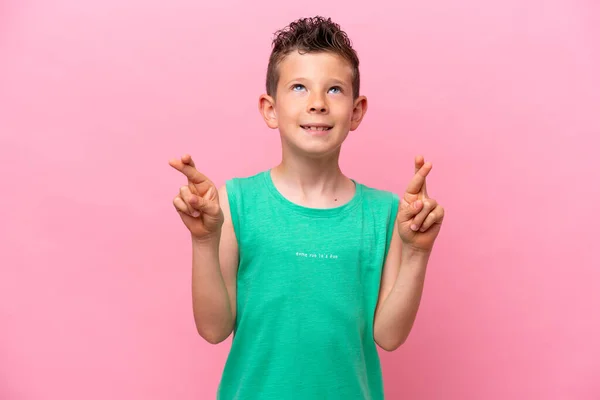Little Caucasian Boy Isolated Pink Background Fingers Crossing Wishing Best —  Fotos de Stock