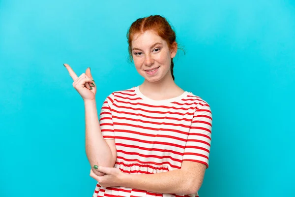 Young Reddish Woman Isolated Blue Background Happy Pointing — Foto Stock