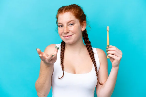 Young Caucasian Reddish Woman Brushing Teeth Isolated Blue Background Making — Φωτογραφία Αρχείου