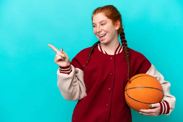 Young Reddish Woman Playing Basketball Isolated Blue Background Pointing Finger — Foto Stock