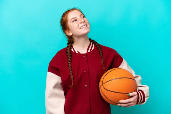 Young Reddish Woman Playing Basketball Isolated Blue Background Laughing —  Fotos de Stock
