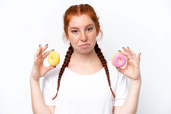 Young Reddish Woman Isolated White Background Holding Donuts Sad Expression — Photo