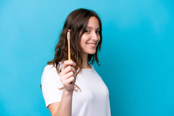 Young Caucasian Woman Brushing Teeth Isolated Blue Background Happy Expression — Stock Photo, Image