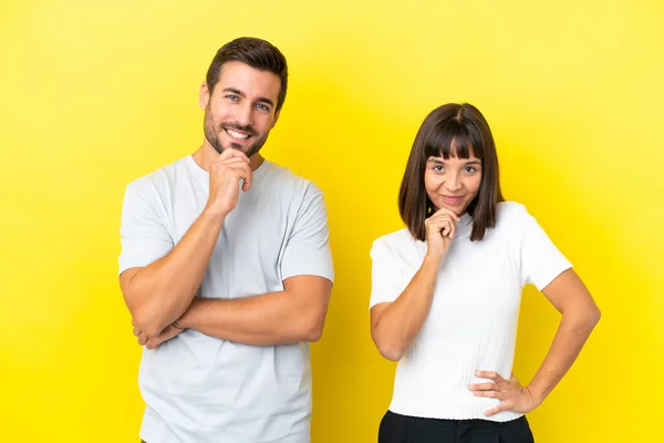 Young Couple Isolated Yellow Background Smiling Looking Front Confident Face — ストック写真