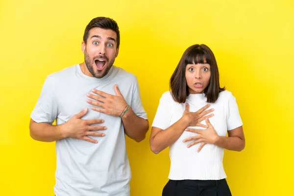 Young Couple Isolated Yellow Background Surprised Shocked While Looking Right — 图库照片