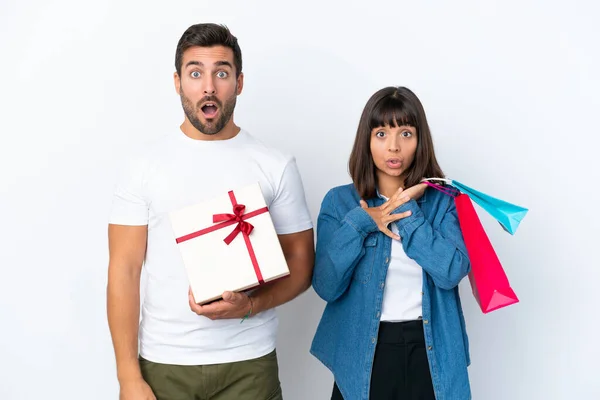 Young Couple Holding Shopping Bags Present Isolated White Background Surprise — Stock fotografie