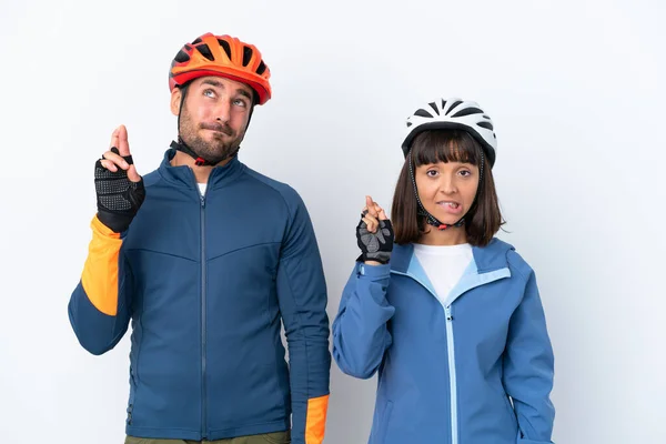 Young Cyclist Couple Isolated White Background Fingers Crossing Wishing Best — Stock Fotó