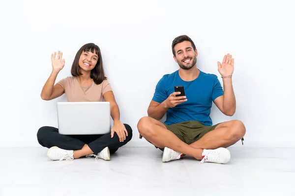 Young Couple Sitting Floor Holding Mobile Phone Isolated White Background — 图库照片