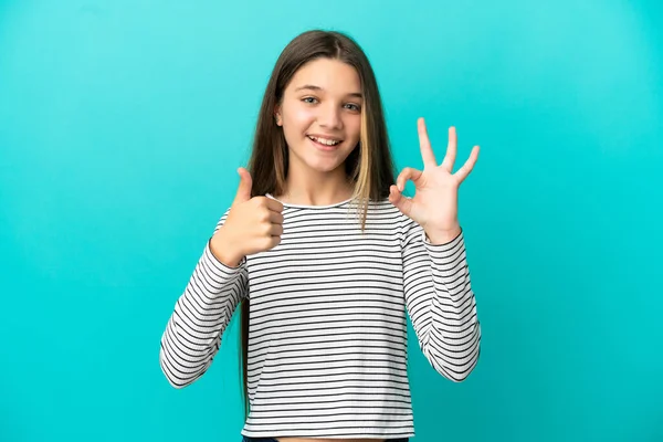 Little Girl Isolated Blue Background Showing Sign Thumb Gesture — 스톡 사진