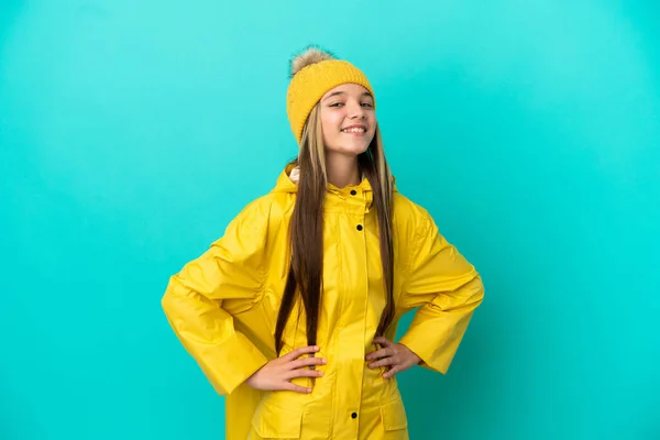 Little Girl Wearing Rainproof Coat Isolated Blue Background Posing Arms —  Fotos de Stock