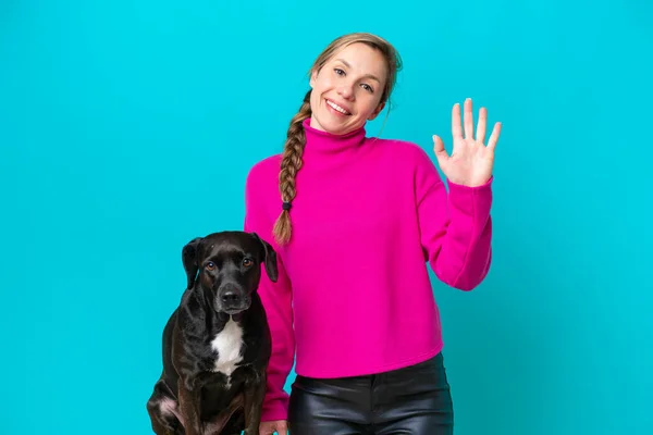Young Caucasian Woman Her Dog Isolated Blue Background Saluting Hand — Zdjęcie stockowe