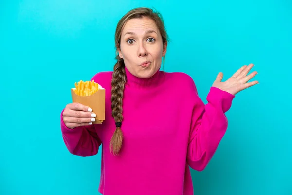 Young Caucasian Woman Holding Fried Chips Isolated Blue Background Having — стоковое фото