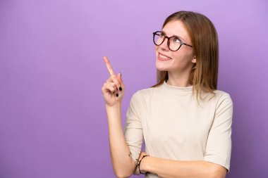 Young English woman isolated on purple background pointing up a great idea
