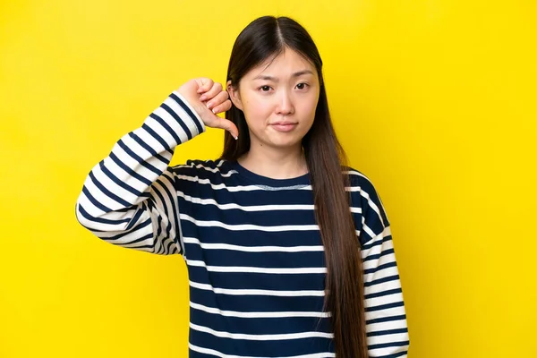 Young Chinese Woman Isolated Yellow Background Showing Thumb Negative Expression — Stock Fotó