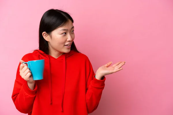 Young Chinese Woman Holding Cup Coffee Isolated Pink Background Surprise — стоковое фото