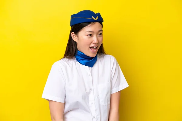 Airplane Chinese Woman Stewardess Isolated Yellow Background Laughing Lateral Position — стоковое фото