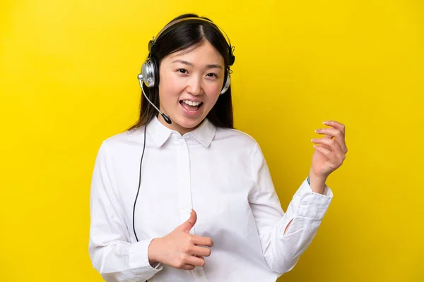 Telemarketer Chinese Woman Working Headset Isolated Yellow Background Making Guitar — Φωτογραφία Αρχείου