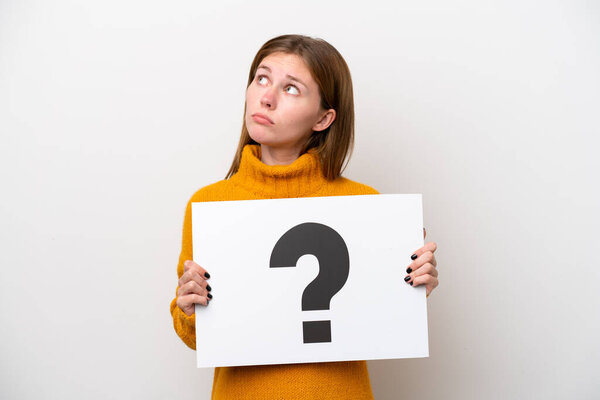 Young English woman isolated on white background holding a placard with question mark symbol and thinking