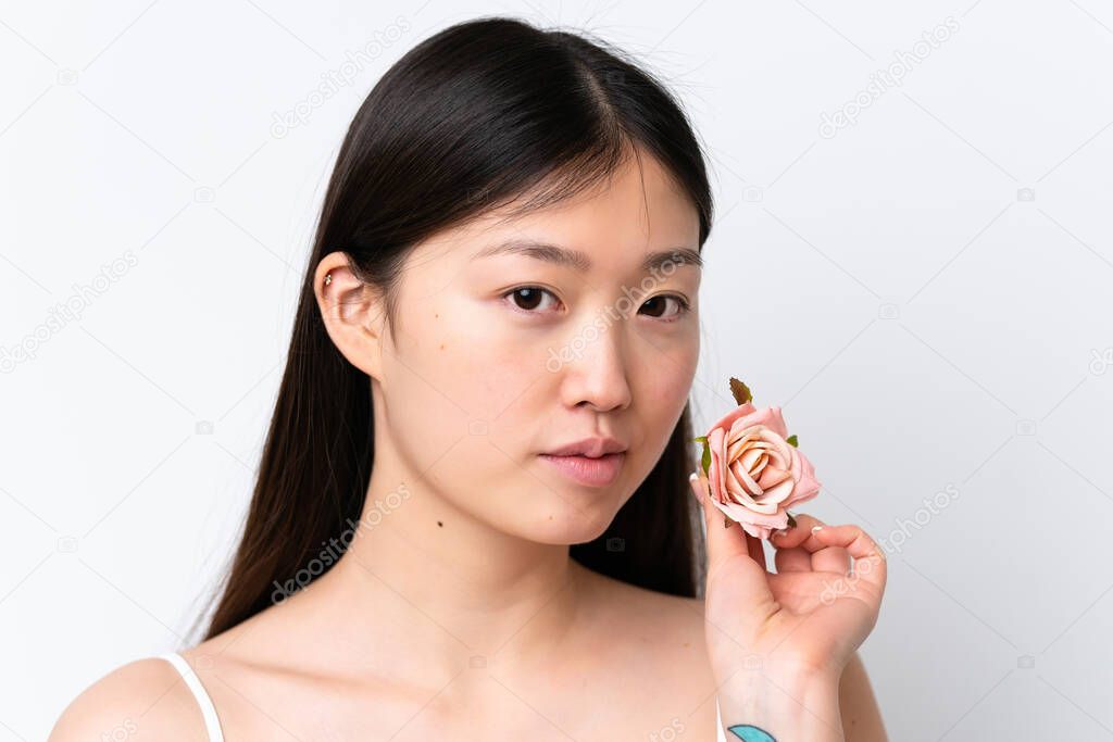 Young Chinese woman isolated on white background holding flowers. Close up portrait