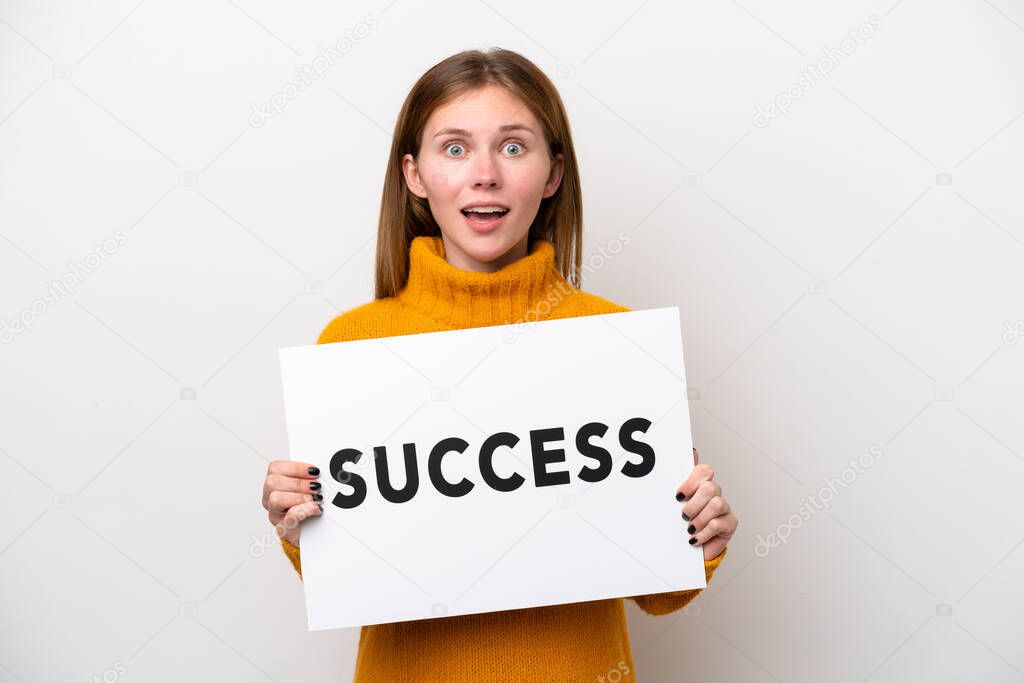Young English woman isolated on white background holding a placard with text SUCCESS with surprised expression