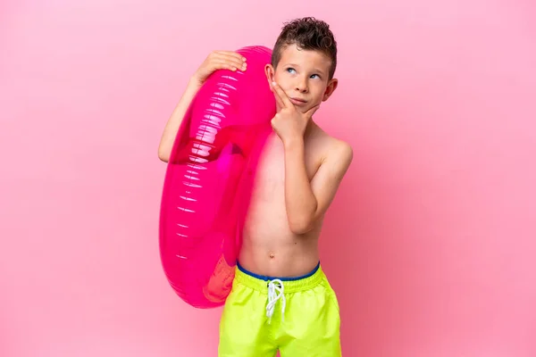 Little Caucasian Boy Holding Inflatable Donut Isolated Pink Background Having — Zdjęcie stockowe
