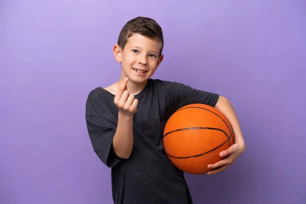 Little Boy Playing Basketball Isolated Purple Background Making Money Gesture — Stok fotoğraf