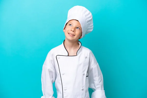 Little Chef Boy Isolated Blue Background Thinking Idea While Looking — Foto Stock
