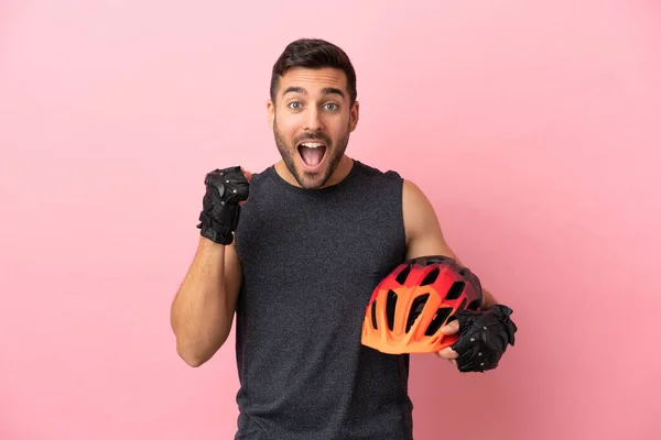 Young Cyclist Man Isolated Pink Background Celebrating Victory Winner Position — Φωτογραφία Αρχείου