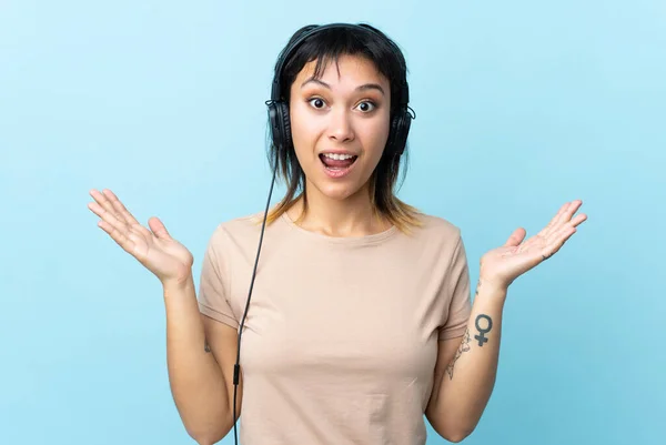 Young Uruguayan Girl Isolated Blue Background Surprised Listening Music — 스톡 사진