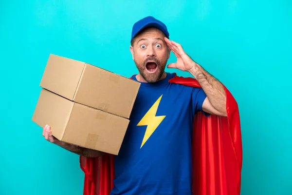 Super Hero Delivery Man Isolated Blue Background Surprise Expression — Zdjęcie stockowe