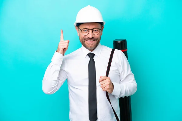 Middle Age Architect Man Helmet Holding Blueprints Isolated Blue Background — Stockfoto