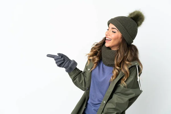 Young Girl Winter Hat Isolated White Background Pointing Finger Side — Stockfoto