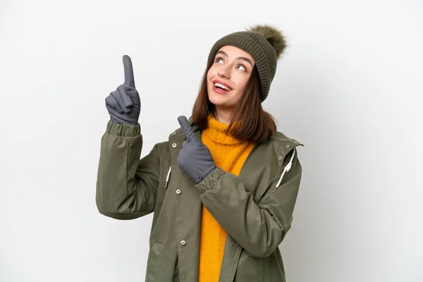 穿着冬季夹克的乌克兰年轻女子 背景是白色的 她用食指指尖着一个很好的主意 — 图库照片