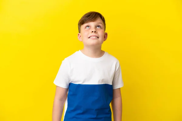 Little Redhead Boy Isolated Yellow Background Thinking Idea While Looking — Stock fotografie