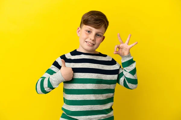 Little Redhead Boy Isolated Yellow Background Showing Sign Thumb Gesture —  Fotos de Stock