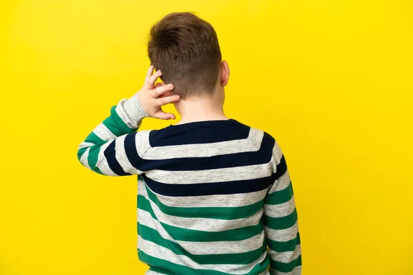 Little Redhead Boy Isolated Yellow Background Back Position Thinking — ストック写真