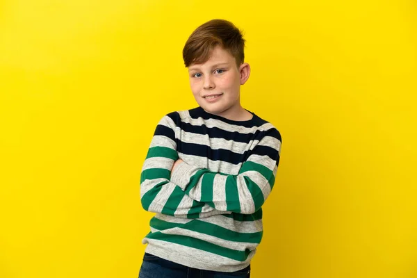 Little Redhead Boy Isolated Yellow Background Arms Crossed Looking Forward — Zdjęcie stockowe