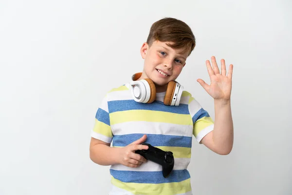 Little Redhead Boy Holding Game Pad Isolated White Background Saluting — Φωτογραφία Αρχείου