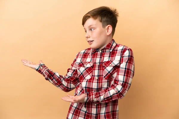 Little Redhead Boy Isolated Beige Background Surprise Facial Expression — Stock Photo, Image