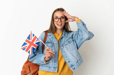 Young hispanic woman holding an United Kingdom flag over isolated white background with surprise expression
