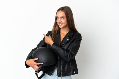 Woman with a motorcycle helmet over isolated white background pointing back