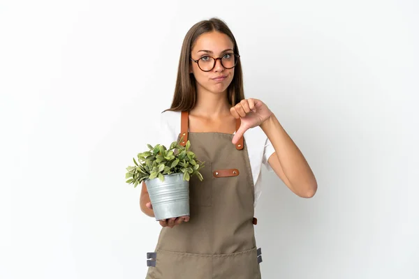 Gardener Girl Holding Plant Isolated White Background Showing Thumb Negative — Stockfoto